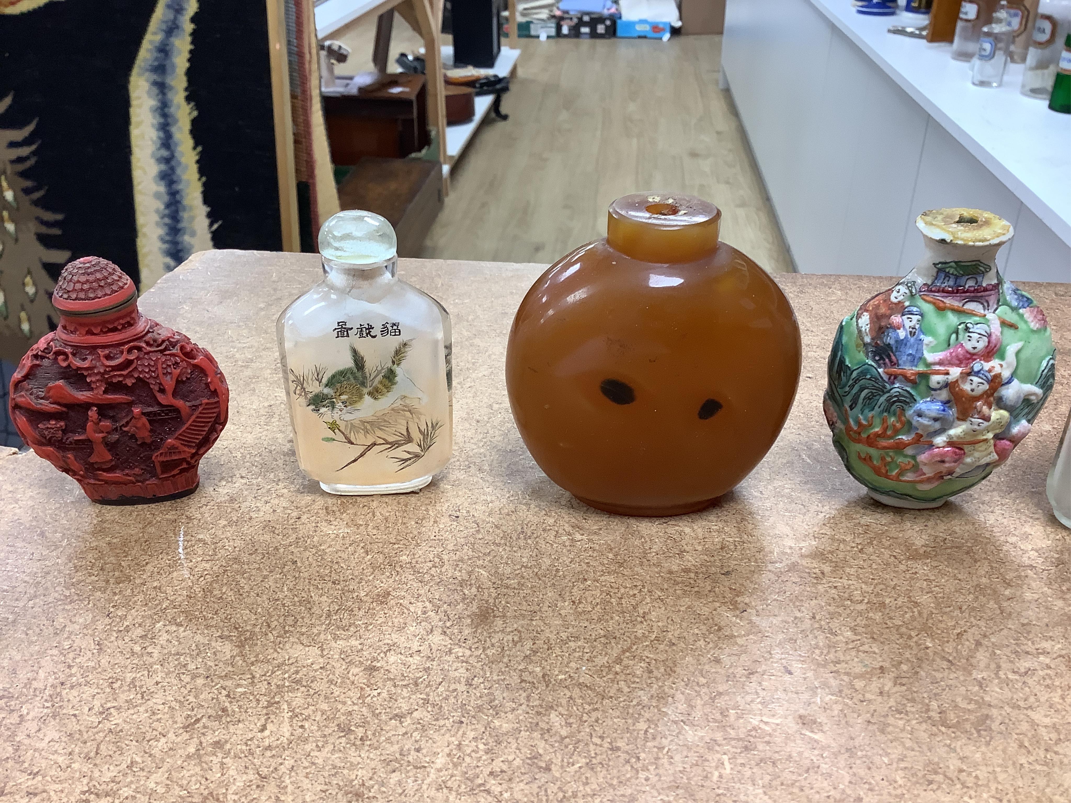 A small collection of Chinese snuff bottles, 19th century and later to include reverse glass painted examples and cinnabar lacquered examples, largest 9.5cm high
